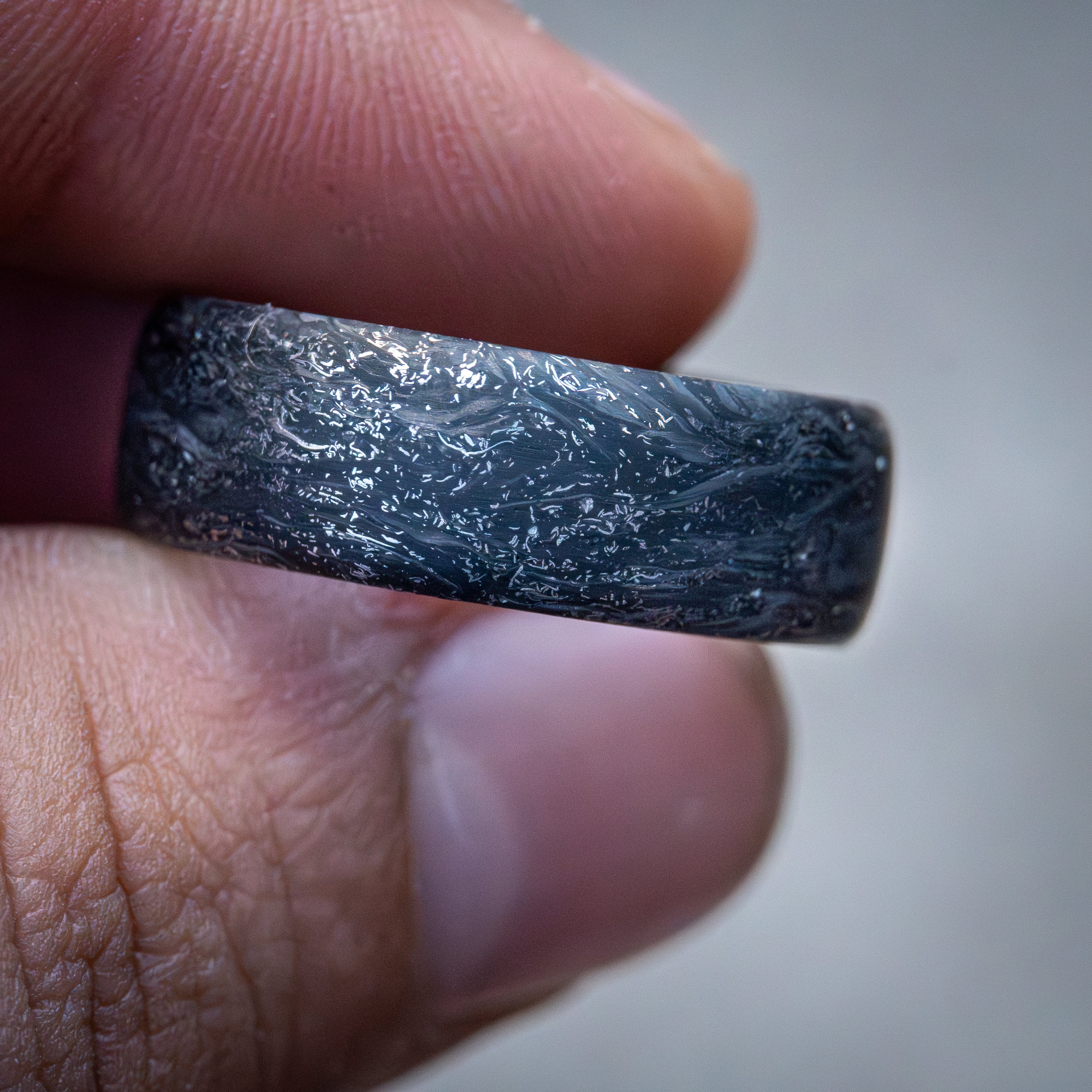 Carbon fiber ring with titanium shavings